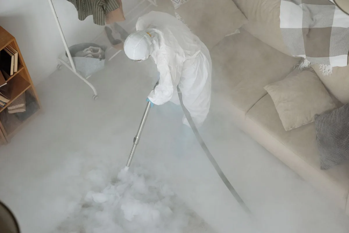 Biohazard cleanup technician in protective equipment, Downtown, Fort Worth, TX